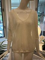 Front view of off-white V-neck linen blend top on mannequin