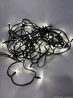 String lights illuminated, tangled on surface