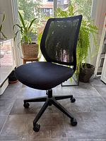 Front three-quarter view of black mesh office chair