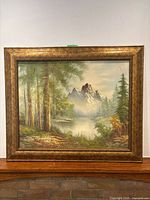 Full view of framed landscape painting on mantle