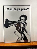 Full view of framed Clint Eastwood poster on wall