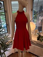 Front full view of red sleeveless dress on mannequin