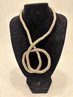 Full view of necklace looped on display bust