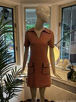 Front view of pink wool shift dress on mannequin