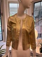 Front view of metallic gold leather jacket on mannequin