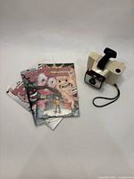 Camera and three comics grouped