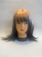Shoulder-length wig, blonde at crown transitioning to dark brown ends, displayed on mannequin
