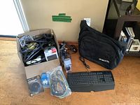 Overall lot showing SSD, cables box, keyboard, Burton bag
