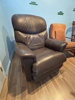 Front view of dark brown vinyl recliner rocking chair