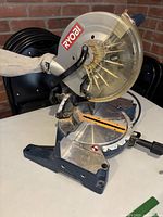Full view of Ryobi compound miter saw on table