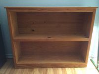 Front view of pine bookcase showing overall appearance and two shelf spaces