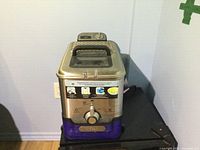 Front view of T-fal deep fryer showing brand badge, oil container window and control decals