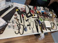 Wide view of assorted tools and hardware laid on table