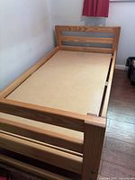 Full view of pine twin bed frame with headboard, footboard and plywood support