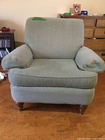 Front view of light gray upholstered armchair