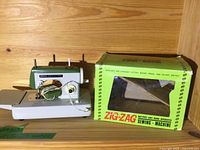 Toy sewing machine left side showing controls and needle area