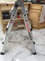 Side view showing Vulcan branding, hinge mechanism, safety labels