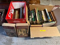 Two boxes filled with assorted books on naturalism and heritage including various titles with hardcovers and paperbacks.