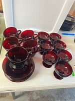 Entire glassware set showing cups, saucers, pedestal bowls, and creamer together on table