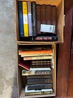 Top view of one box showing several books including 'Inside the FBI', history and essay books with various bindings and colors.