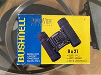 Bushnell Powerview binoculars retail box front showing model 8x21 and features