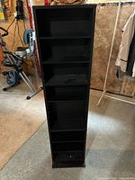 Front view showing seven shelves and black finish