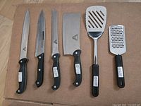 Group of Falcon Crest knives, spatula, grater