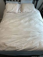 Queen bed setup showing white duvet cover and pillow cases