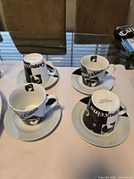 four cappuccino cups and saucers