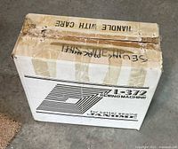 Cardboard box labeled Janome L-372 sewing machine