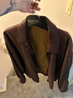 Front view brown leather jacket on Benzing Charlesbois hanger