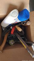 Boxed view showing assorted tools, chain, flashlight, shelf liners