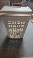 Front view of Sterilite vented laundry hamper with lid