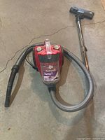 Canister vacuum with hose and wand assembled