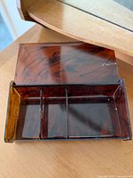 Top-open view of the Lucite box showing interior two compartments with faux tortoiseshell finish.
