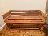 Full frontal view of cedar wooden bench with shoe shelf underneath