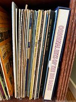 Side view of vintage vinyl records including 'Original Hits of the Big Bands' boxed set.