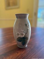 Front angle view of vintage Bing & Grondahl Denmark porcelain vase showing floral design on glossy white background.