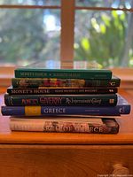 Stack of six art and travel books, including three on Monet and two on Greece, showing the spines and titles for identification