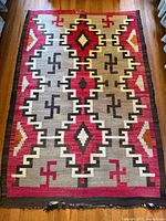 Full view of the rug laid flat on wood floor showing overall design and dimensions