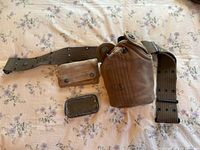 Top view showing all items spread out - canteen in fabric carrier, adjustable belt, small first aid pouch, and metal box.
