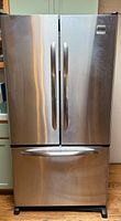 Front view of the Kenmore Elite stainless steel refrigerator showing the French door design and bottom freezer drawer.