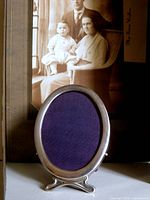 Front view of oval sterling frame with blue insert