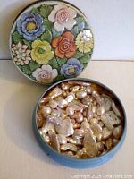 Open tin showing quantity and variety of pearls