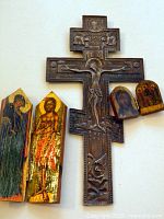 Front view of metal crucifix with two wooden icons
