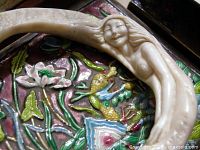 Close-up of mermaid figure and carving detail on bangle