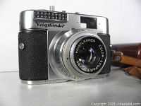 Front view of Voigtländer camera showing lens, brand name and meter