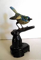 Full view of bird figurine on base
