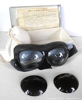 Goggles with clear lenses, spare dark lenses, box and insert visible