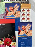 Christmas Noël angel booklets, maple leaf US rate booklet, floral booklet visible